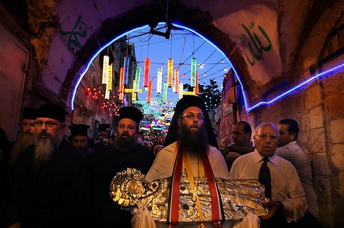 A Greek Orthodox priest carries an icon